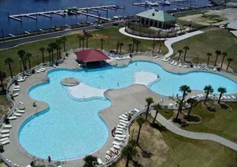 aerial photo of pool with marina and dock, lounge chairs all around pool and tiki bar, myrtle beach pet friendly vacation rental home